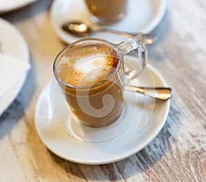 Image of cup of fresh coffee cortado on table photo