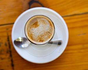 Image of cup of fresh coffee cortado on table photo