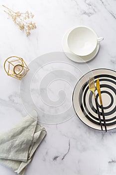 Image of cutlery sets with plate, cup and candle. Party theme, place and table setting