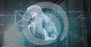 Image of cyberattack and envelope icons over and using computer mouse server room