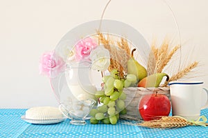 image of dairy products and fruits over wooden background. Symbols of jewish holiday - Shavuot.