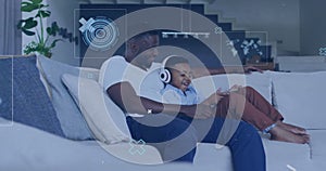 Image of data processing over african american father and son using tablet