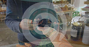 Image of data processing over biracial man paying with smartphone