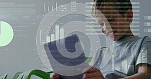 Image of data processing over caucasian boy using tablet