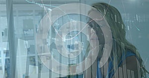 Image of data processing over caucasian businesswoman in office