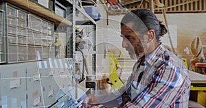 Image of data processing over caucasian male carpenter working in workshop