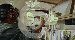 Image of data processing over caucasian male carpenter working in workshop