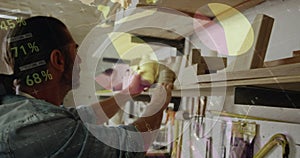 Image of data processing over caucasian male carpenter working in workshop