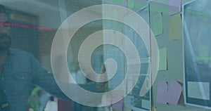 Image of data processing over diverse business people taking notes