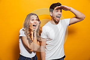 Image of delighted man and woman 20s in basic clothing screaming