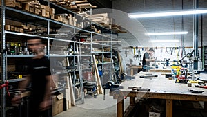 Workers in a busy woodworking shop