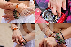 Image detail of henna being applied to hand. a lot of jewelry on the arms, bare belly. partial focus, art blur