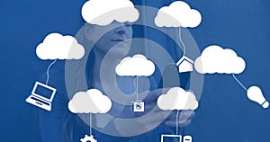 Image of digital clouds with icons over woman using smartphone photo