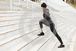 Image of disabled running girl with prosthetic leg in sportswear