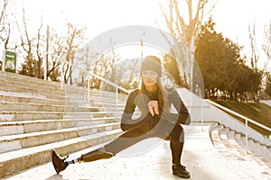 Image of disabled running girl in sportswear, doing sit ups and