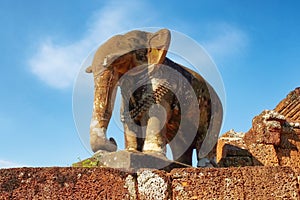 An image displaying a medieval sculpture of an elephant located in East Mebon, Cambodia