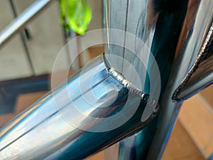 The image displays a close-up of a weld bead, likely created using a TIG Tungsten Inert Gas welding process