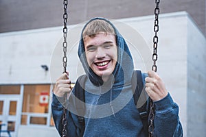 Happy teenager on a swing.