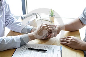 Image of doctor holding patient`s hand to encourage, talking with patient cheering and support