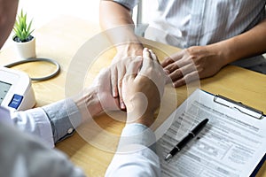 Image of doctor holding patient`s hand to encourage, talking with patient cheering and support