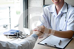 Image of doctor holding patient`s hand to encourage, talking with patient cheering and support