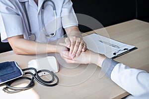 Image of doctor holding patient`s hand to encourage, talking with patient cheering and support