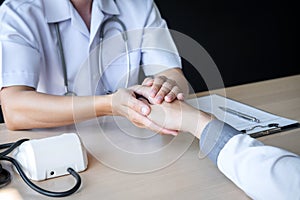 Image of doctor holding patient`s hand to encourage, talking with patient cheering and support