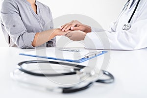 Image of doctor holding patient`s hand to encourage, talking with patient cheering and support, healthcare and medical assistant