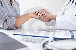 Image of doctor holding patient`s hand to encourage, talking with patient cheering and support, healthcare and medical assistant