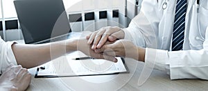 Image of doctor holding patient`s hand to encourage, talking with patient cheering and support, healthcare and medical assistant