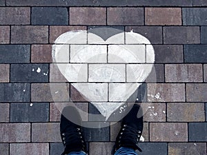 An image of a drawn heart on a surface. Drawn in white paint. A symbol of love and fidelity