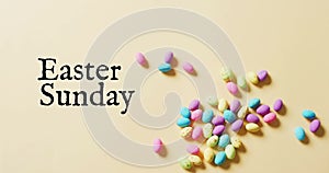 Image of eastersunday text over colourful easter eggs on yellow background