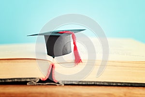 Image of education concept. Traditional graduation hat over books