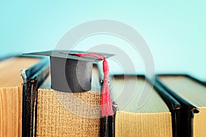 Image of education concept. Traditional graduation hat over books