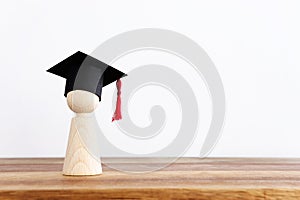 Image of education concept. Wooden people figure with graduation hat