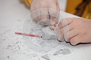 Image of an educational game to find fossils for a small archaeologist, with children`s hands digging