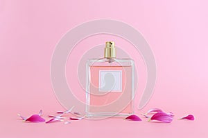 Image of elegant perfume bottle over pink pastel background