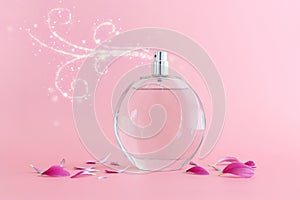 Image of elegant perfume bottle spraying over pink pastel background photo