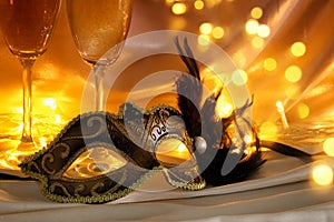 Image of elegant venetian mask and glasses of champagne over gol