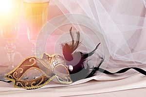 Image of elegant venetian mask and glasses of champagne over gol