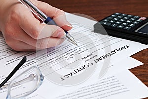 Image of employee signs employment contract, close-up