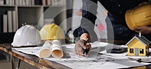 Image of engineer drawing a blue print design building or house, An engineer workplace with blueprints, pencil