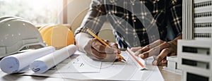 Image of engineer drawing a blue print design building or house, An engineer workplace with blueprints, pencil