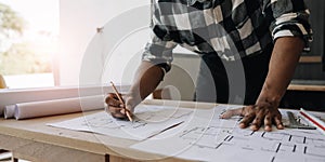 Image of engineer drawing a blue print design building or house, An engineer workplace with blueprints, pencil