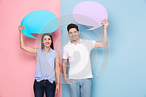 Image of european man and woman holding copyspace bubbles for an