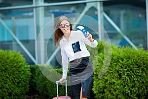 Image of European Woman Having Beautiful Brown Hair Smiling While Holding Passport and Air Tickets