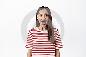 Image of excited surprised girl drop jaw, scream from amazement and looking at camera amazed, staring in awe at surprise