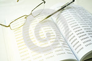 Image of eyeglass and pen on empty notepad. financial concept, selective focus