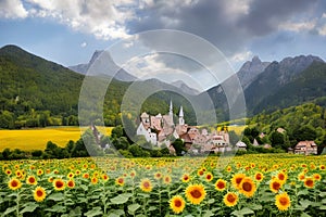 image of a fairy tale village against the beautiful landscape of tree,mountain, field of greenery and flowers.