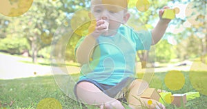 Image of falling dots over happy caucasian happy baby photo